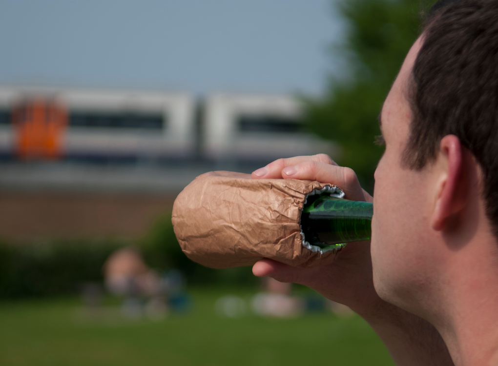 Man drinking beer in a brown paper bag drinks cooler